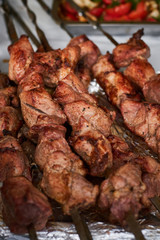 barbecue meat on skewers. grilled meat on open grill. street food