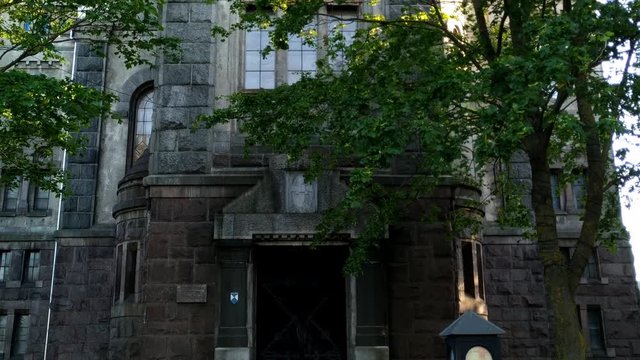 Looking up the walkway and the tower of the Lutheran Holy Trinity Cathedral in Liepaja, Latvia, hidden behind trees