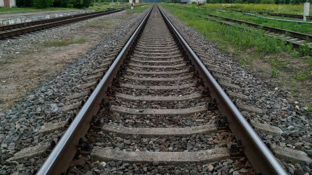 Looking up from the middle of the train tracks into the horizon at Skrunda Railway Station, Latvia
