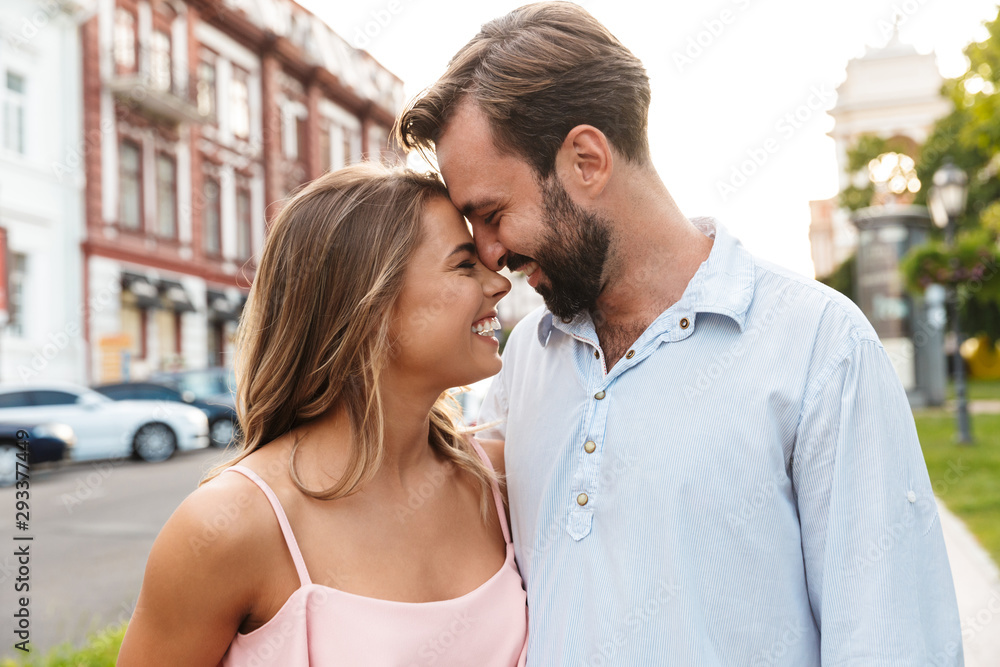 Wall mural close up of a happy beautiful couple embracing