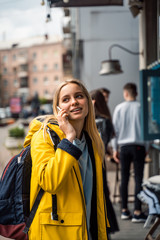Fototapeta premium Woman walking and using a smartphone in the street