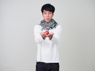 Young handsome holding red christmas ball