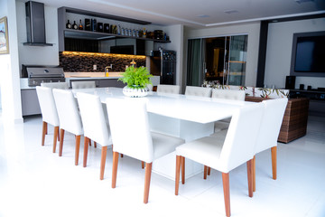 modern dining room with white table and chairs