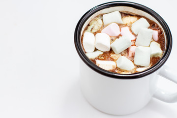 Fototapeta na wymiar coffee with marshmallows in a white metal mug. hot drink in a mug on a white background
