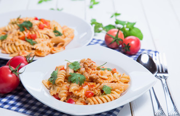 Spaghetti pasta with and tomato sauce on wood background