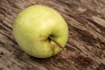 natural and healthy green apple on a wooden table
