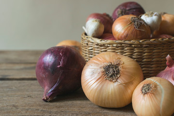 Fresh , organic onions in basket on old wooden table