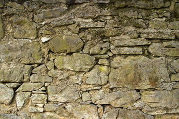 Wall of old weathered boulders in detail