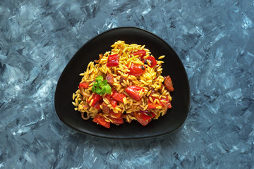 Roasted pepper and chorizo orzo salad combines red peppers, red onion, chorizo and cherry tomatoes with orzo pasta. 