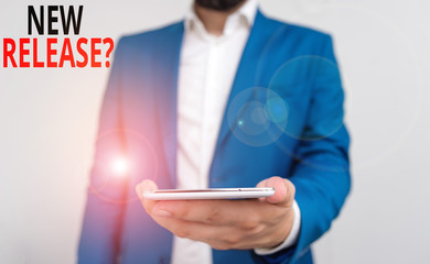 Word writing text New Release Question. Business photo showcasing asking about recent product or service newly unleashed Business concept with man holding mobile phone with touch screen