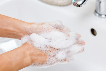 Fototapeta premium Hygiene concept. Washing hands with soap under the faucet with water