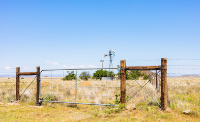 Fototapeta premium Windmill on a farm in rural grassland area of South Africa