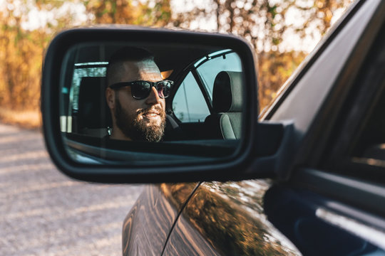 Cute, Bearded Guy Driving A Car, Reflection In Car Rearview Mirror.