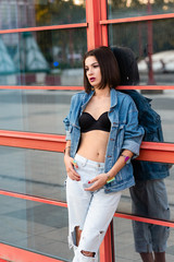 Portrait of young fashionable woman wearing jeans