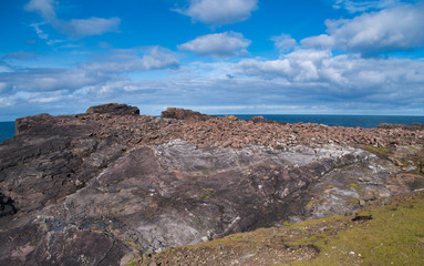 Obraz premium Coast rock formations at Eshaness on Shetland, Scotland, UK - the rocks are of the Eshaness Volcanic Formation - pyroclastic-rock (ignimbrite) - igneous bedrock formed in the Devonian Period.