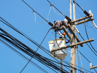 electrician man working at height and dangerous ,high voltage power line maintenance