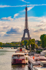 Nice portrait view of the iconic Eiffel Tower with ships anchored at the Port de Javel Haut at the...
