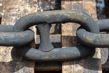 Rusty anchor chain in dry dock