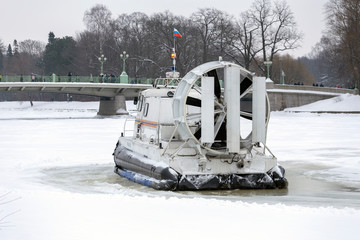 Boat hovercraft on white ice snow in winter.