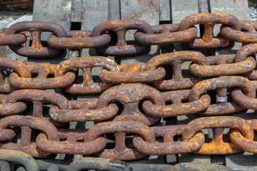 Rusty anchor chain in dry dock