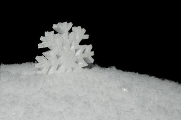white Styrofoam figurine snowflake on snow