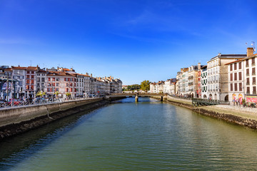 Naklejka na ściany i meble Bayonne, France - View of restaurants and the Nive of the city of Bayonne.
