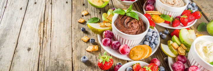 Vegan food for breakfast, snack. Homemade Sweet Hummus with strawberries, apple, crackers, grapes....