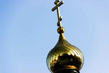 green domes of the chirch lit in the setting sun