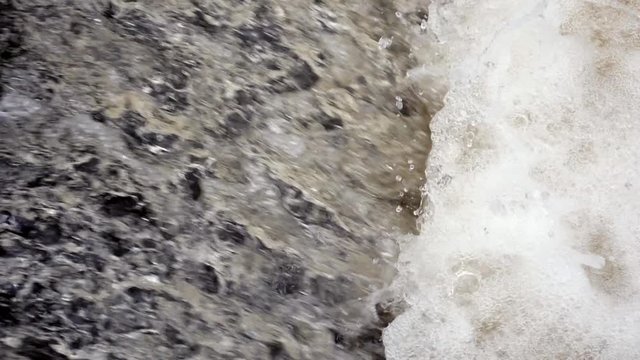 Gushing flood water in slow motion.  Water flowing over a weir shot at 150fps.