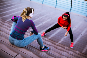 Two young women doing gymnastic exercises outdoor