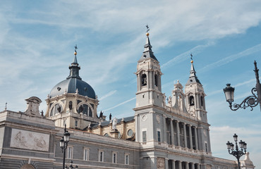 Fototapeta na wymiar view of the Cathedral of Santa Maria la Real de la Almudena in a sunny day with clead blue sky and clouds.