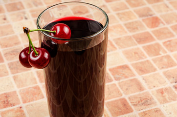 Ripe cherries and a glass of juice