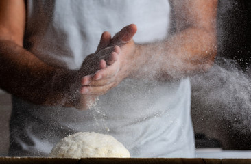 Man hands, flour and dough.