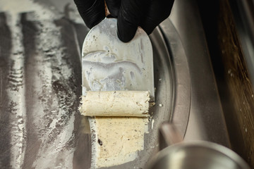 man making icecream rolls
