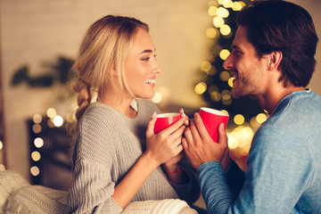 Couple in love drinking tea and enjoying winter holidays