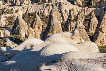 Aerial view of various rocks and Cave hotel in the valley of Goreme in the daytime, built in rock formation in national park Goreme,Cappadocia ,Turkey.