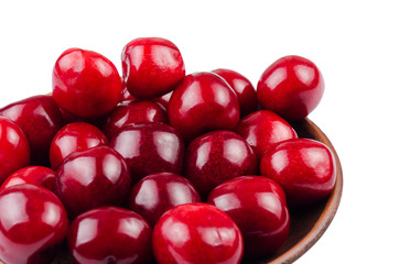 Cherries in a clay bowl on a white background