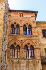 Old house facade with mullioned windows in italy
