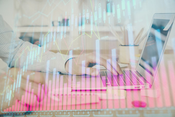Multi exposure of stock market graph with man working on laptop on background. Concept of financial analysis.