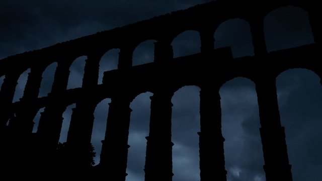 The Aqueduct of Segovia (or the aqueduct bridge) Thunderstorm and Lightning Time Lapse, Elevated Roman Aqueducts and Symbol of City, Spain