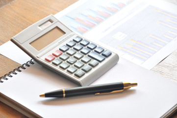 calculator and graph paper with business concept