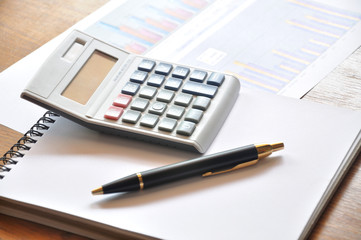 calculator and graph paper with business concept