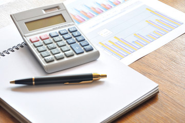 calculator and graph paper with business concept