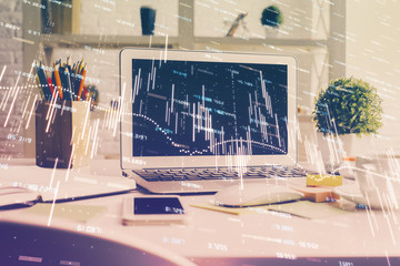 Forex market graph hologram and personal computer on background. Double exposure. Concept of...