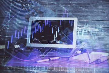 Financial graph colorful drawing and table with computer on background. Multi exposure. Concept of international markets.