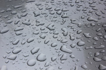 Water drop on the bronze car hood for background.Selective focus.