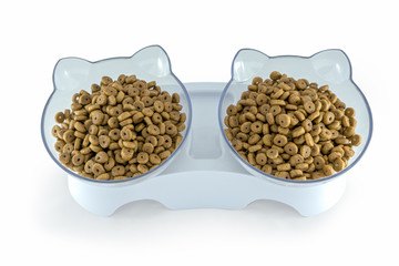 Dry cat food in a cat shaped bowl isolated on white background with clipping path