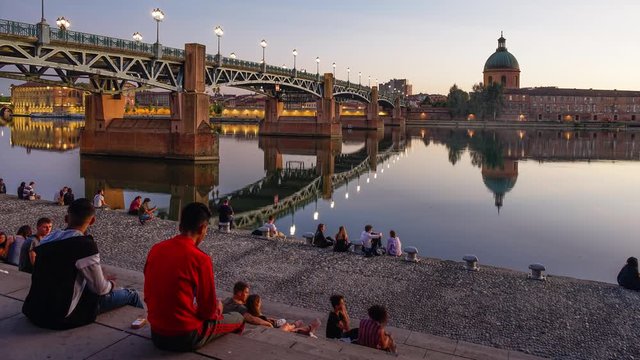 day to night timelapse of the banks of the Garonne river in the town of  Toulouse