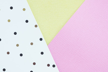 Abstract pink, yelow and white paper background with black and brown polka dots...