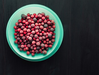 Plate with fresh frozen red cranberries